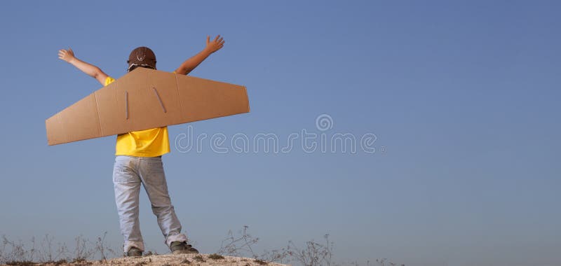 Happy boy with cardboard boxes of wings against sky dream of fly royalty free stock photos Happy boy with cardboard boxes of wings against sky dream of fly royalty free stock photos