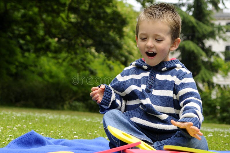 Happy boy having fun with numbers in park