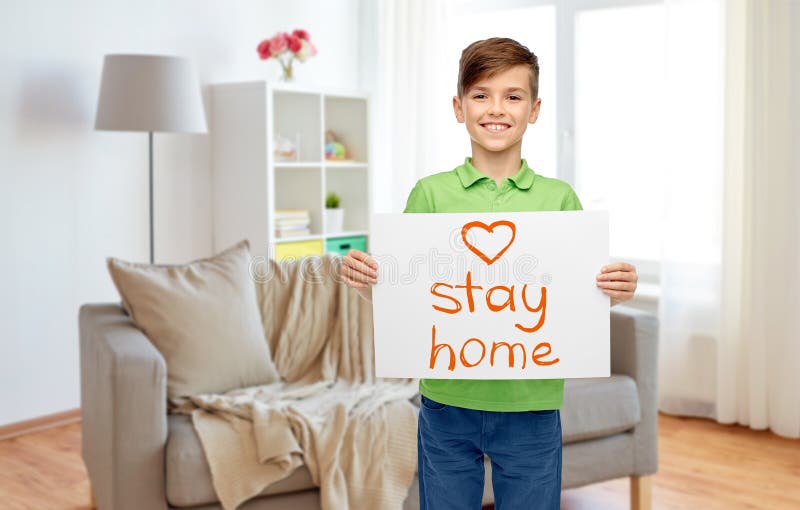Happy boy holding stay home message on paper royalty free stock image Happy boy holding stay home message on paper royalty free stock image
