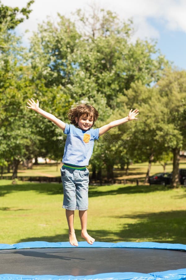 Happy Boy Jumping High on Trampoline in the Park Stock Photo Image of