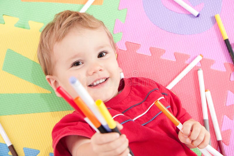 Happy boy with kids drawing pens