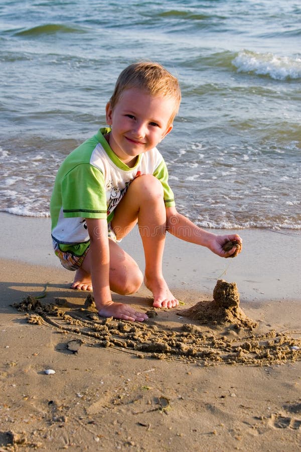 The happy boy plays sand