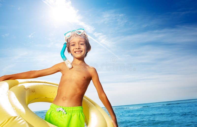 Happy boy with scuba mask and swimming ring