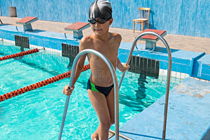 Happy boy in Swimming Pool standing at the edge