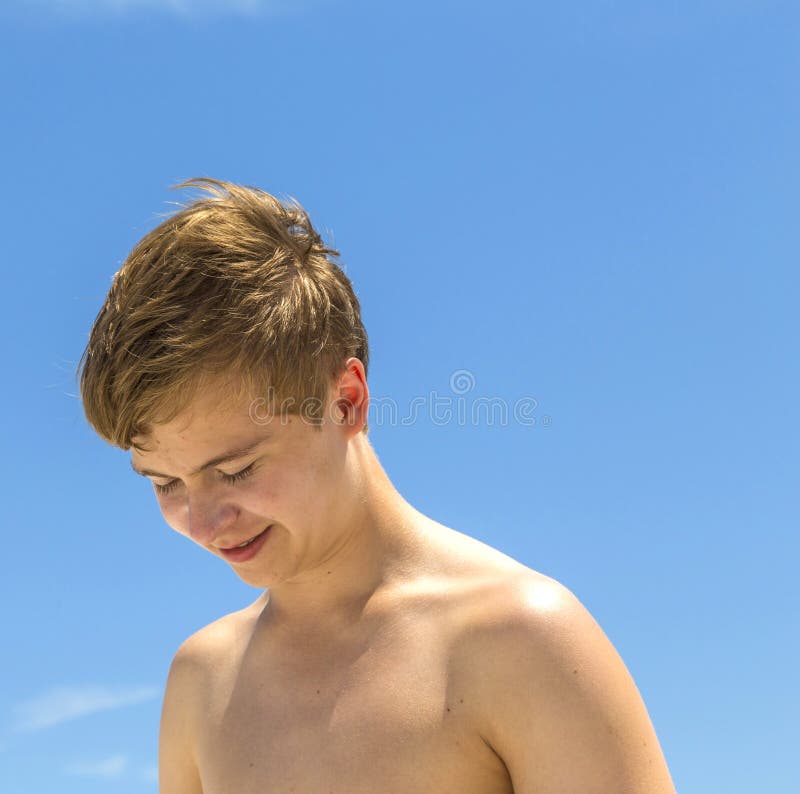 Happy boy after swimming at the sunny beach