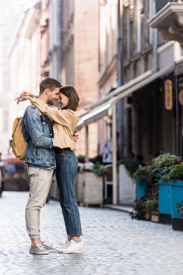 Happy boyfriend and girlfriend hugging in stock images