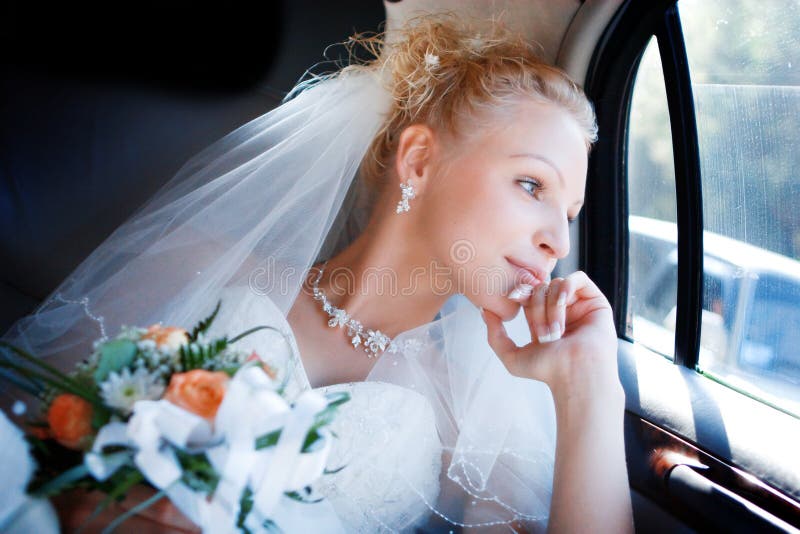 Happy bride in the car