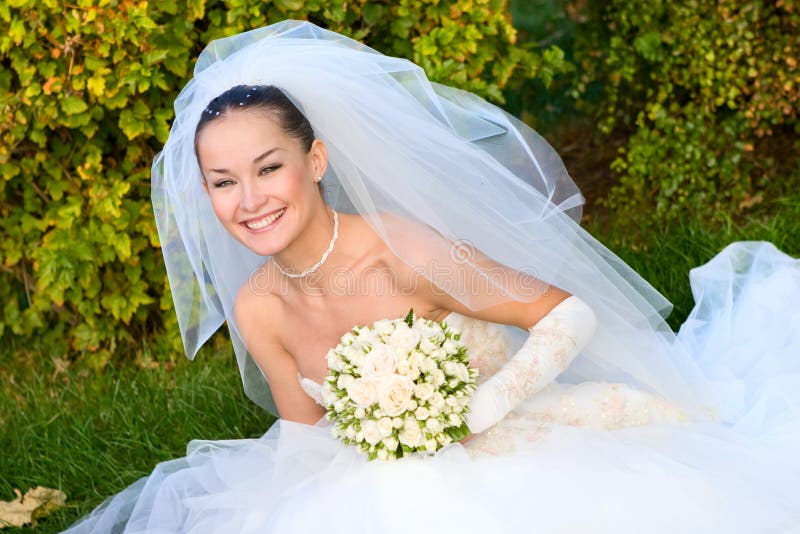 Happy bride with a flower bouquet in her hands