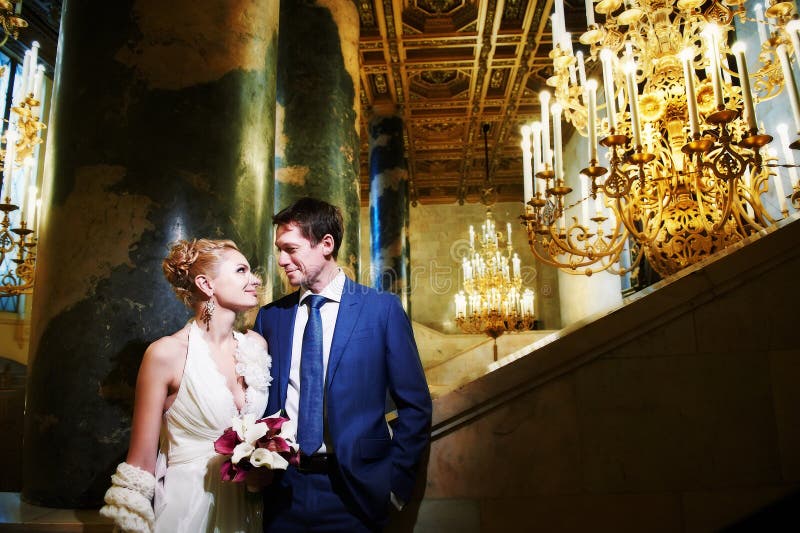 Happy bride and groom in interior of hotel