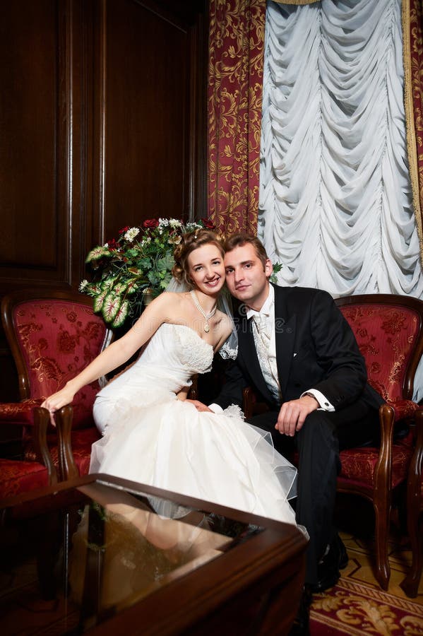 Happy bride and groom in luxury chairs