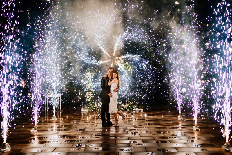 bride and groom are standing in the hallway of the fountains of the fireworks