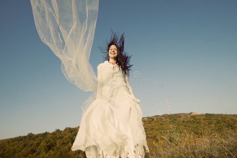 Happy bride with red boots jumping