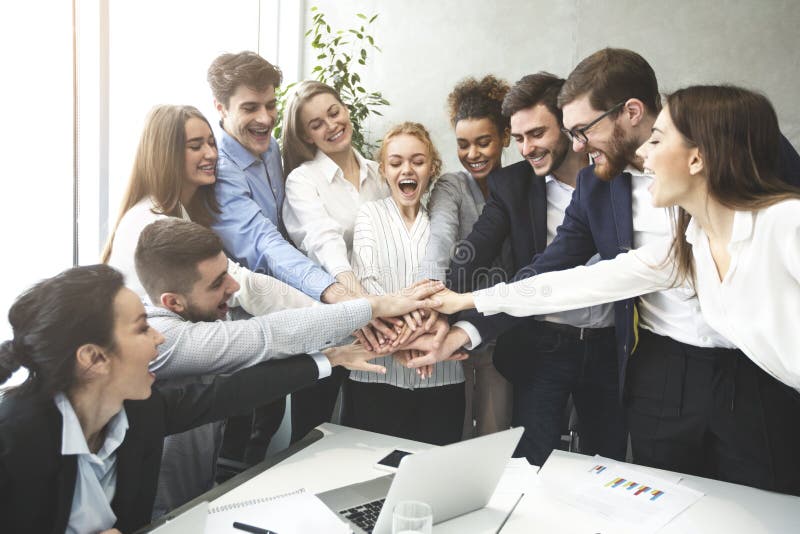 Happy business team joining hands together, celebrating success stock photography Happy business team joining hands together, celebrating success stock photography
