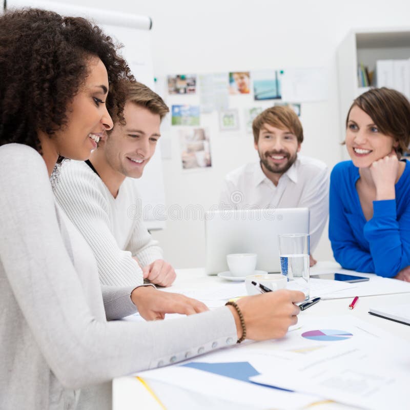 Happy business team sitting in a meeting stock images