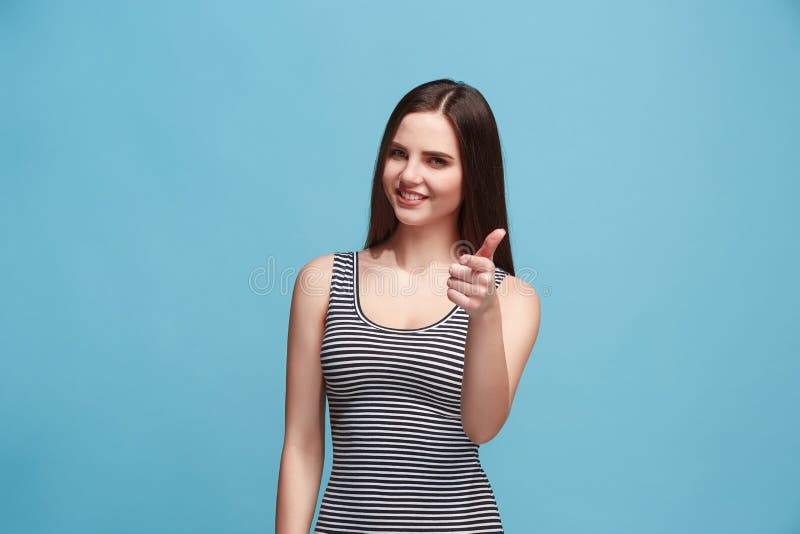The happy business woman standing and smiling against blue background. royalty free stock photos The happy business woman standing and smiling against blue background. royalty free stock photos