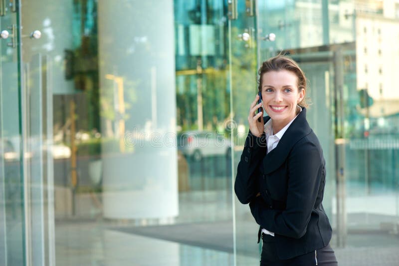 Happy business woman walking and calling by cell phone stock photos Happy business woman walking and calling by cell phone stock photos