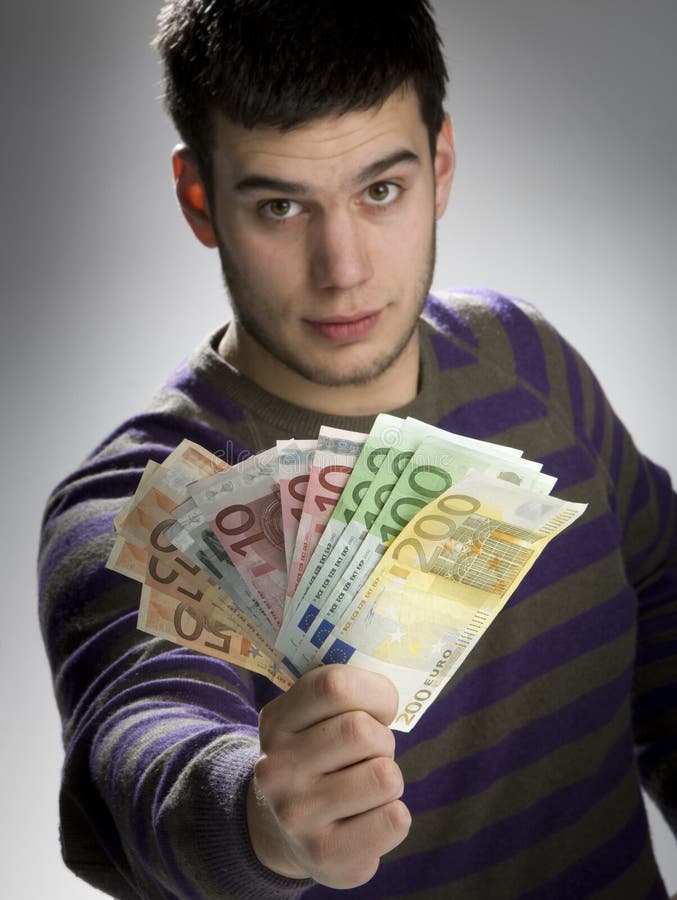Happy businessman with bundle of euro money