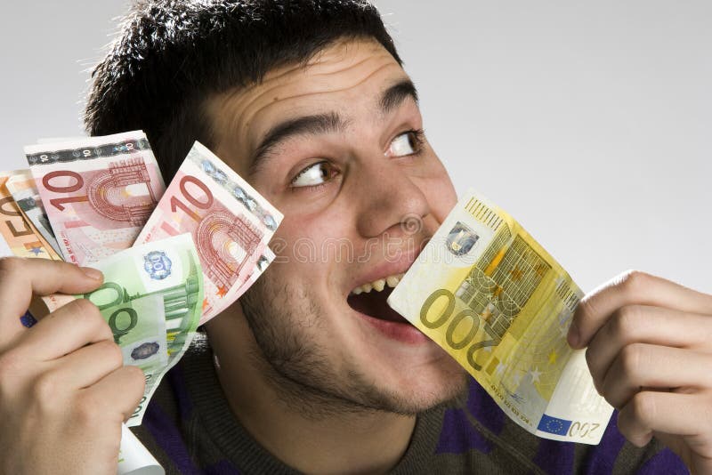 Happy businessman with bundle of euro money