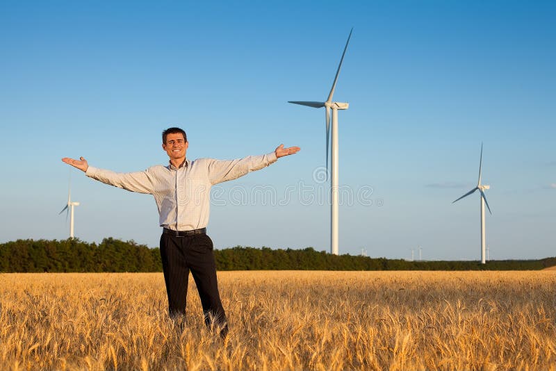 Happy businessman in a field