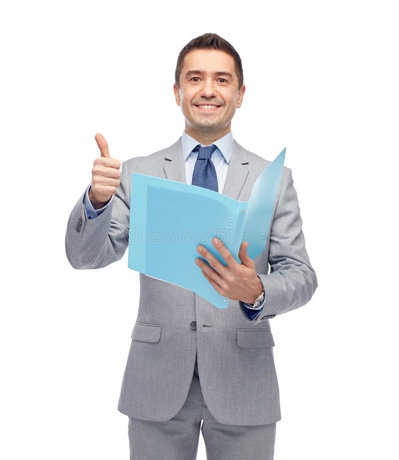 Business, people, finances and paper work concept - happy smiling businessman in suit holding folder and showing thumbs up. Business, people, finances and paper work concept - happy smiling businessman in suit holding folder and showing thumbs up