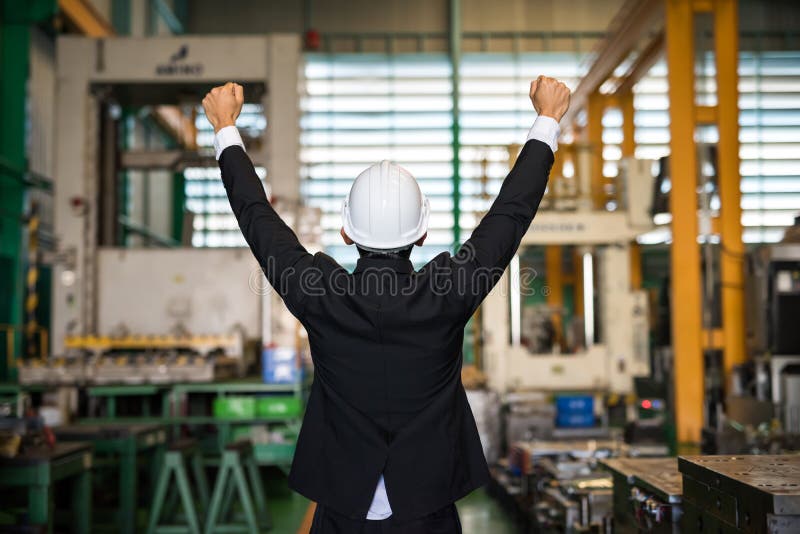 Happy businessman with helmet in factory royalty free stock images Happy businessman with helmet in factory royalty free stock images
