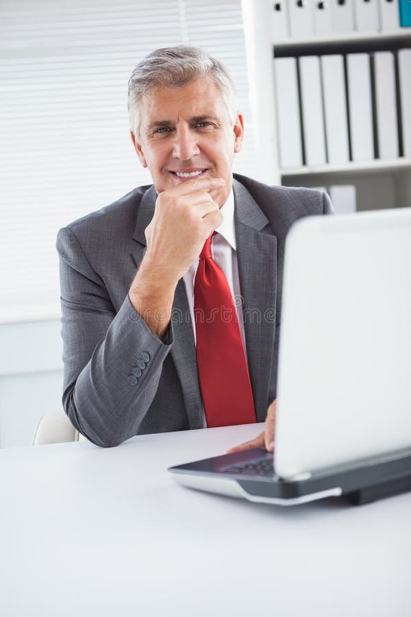Happy Businessman at His Desk Stock Photo Image of notebook, desk