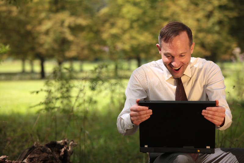 Happy businessman with laptop