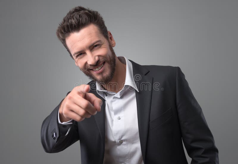 Happy businessman laughing and pointing finger