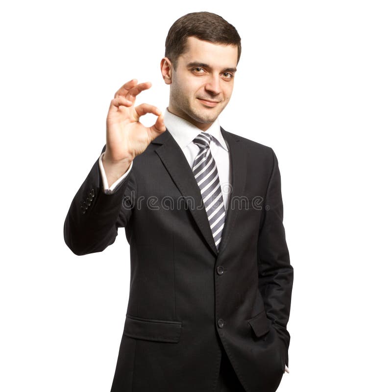 Happy businessman in suit shows OK royalty free stock photography