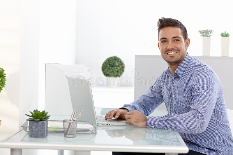 Happy businessman working on laptop royalty free stock photography