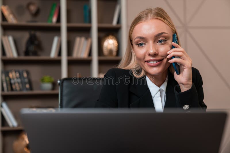 Happy businesswoman calling on the phone, working with laptop in royalty free stock images