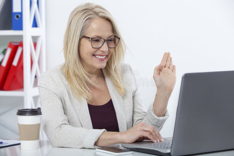 Happy businesswoman with glasses working, chating with laptop at office