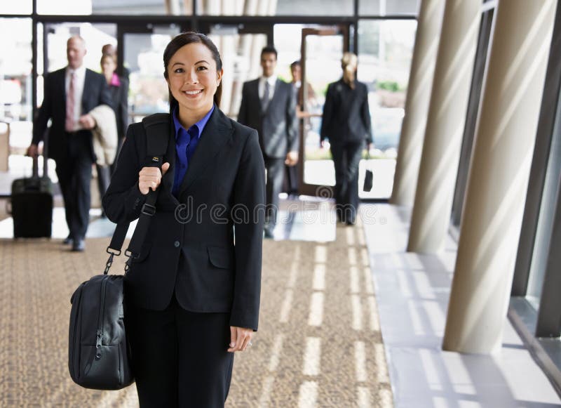 Happy businesswoman in suit holding briefcase stock photos Happy businesswoman in suit holding briefcase stock photos