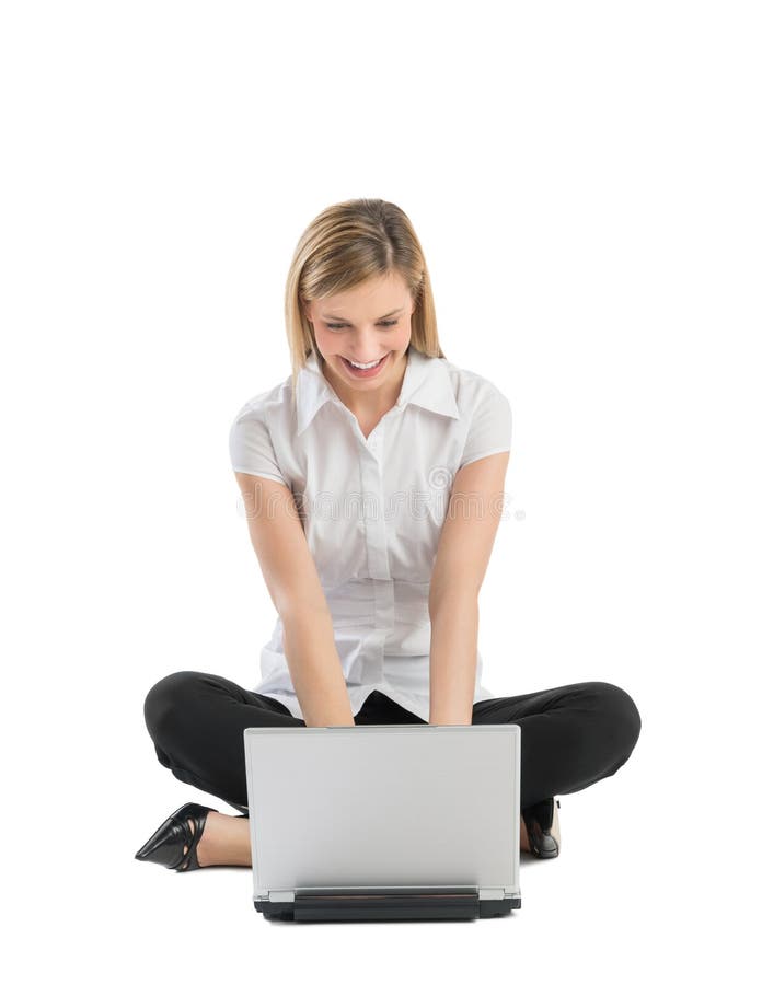 Happy Businesswoman Using Laptop While Sitting On Floor
