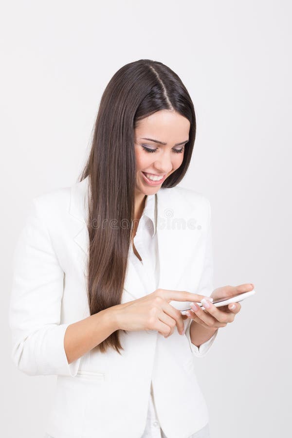 Happy businesswoman wearing white using smartphone stock photos Happy businesswoman wearing white using smartphone stock photos