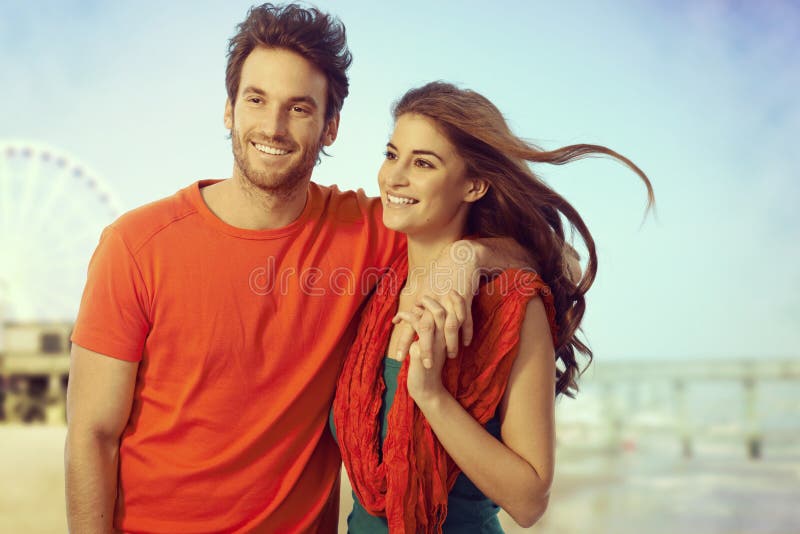 Happy casual couple walking at seascape beach