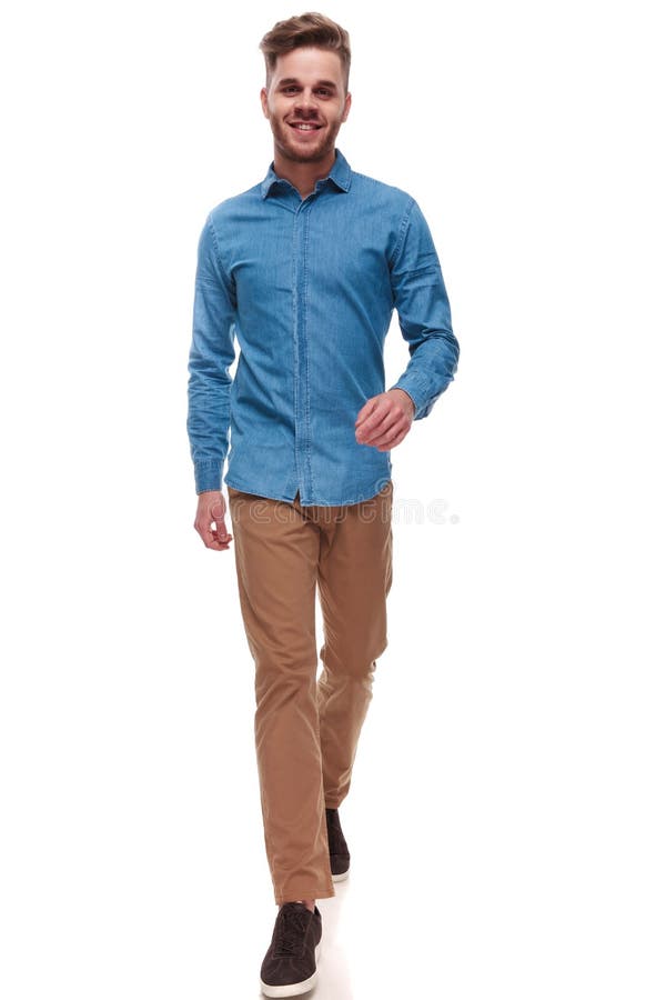 Happy casual man with blue shirt walking forward
