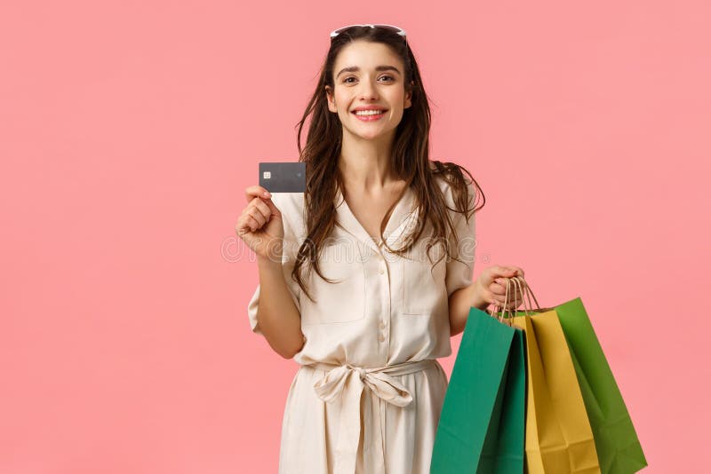 Happy caucasian brunette-vrouw in stijlvolle jurk, draagtassen en creditcard, die alles betaalt met een paypass stock foto Happy caucasian brunette-vrouw in stijlvolle jurk, draagtassen en creditcard, die alles betaalt met een paypass stock foto