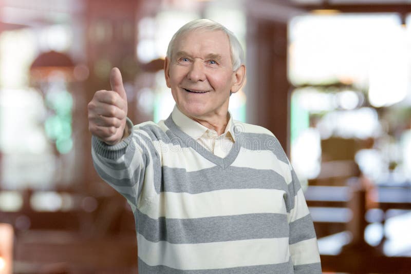 old man thumbs up stock photo
