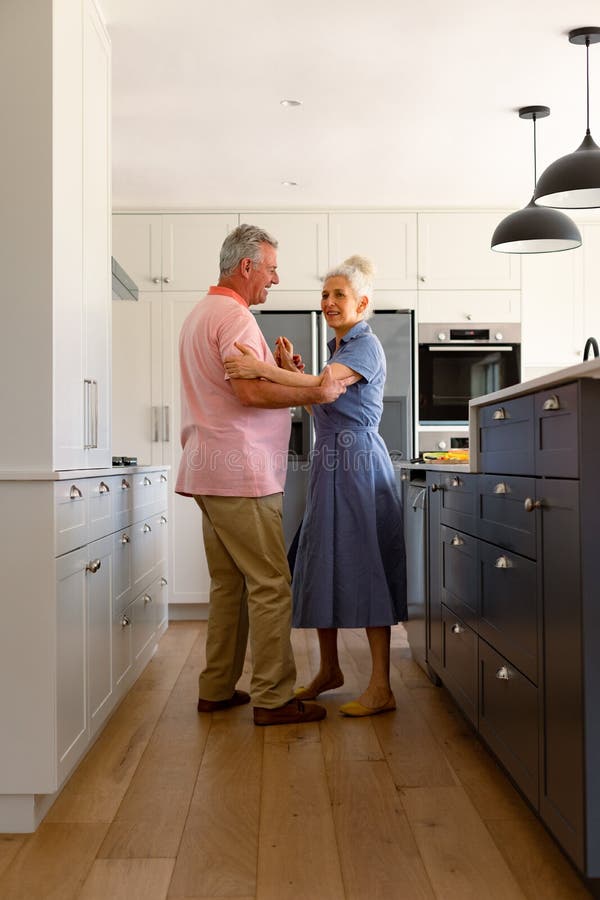 Happy Caucasian Senior Couple Dancing Together In Kitchen And Having Fun Stock Image Image Of 