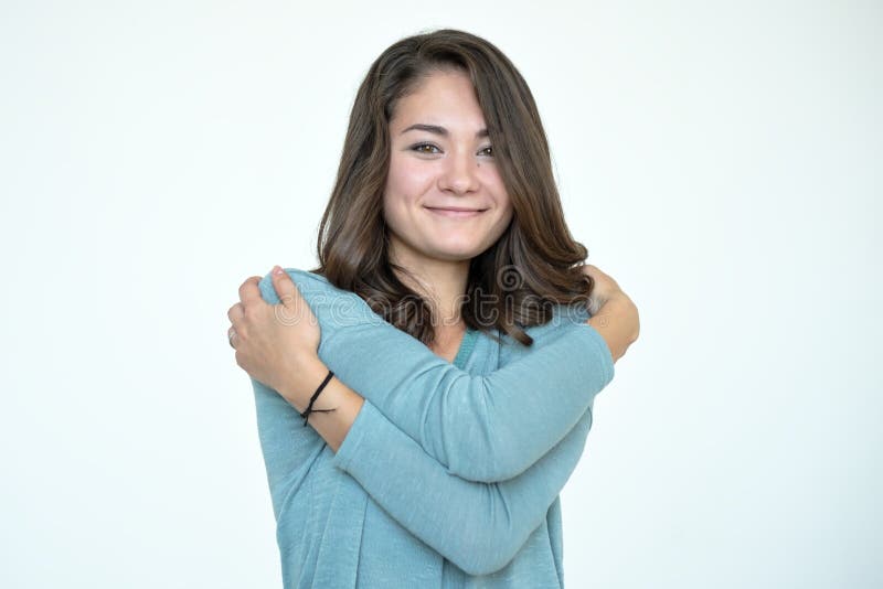 Happy caucasian woman hugging herself with natural emotional enjoying face. royalty free stock photography Happy caucasian woman hugging herself with natural emotional enjoying face. royalty free stock photography