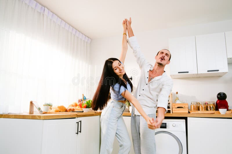 Happy Cheerful Caucasian Couple Dancing Together In The Kitchen Spending Time Together 