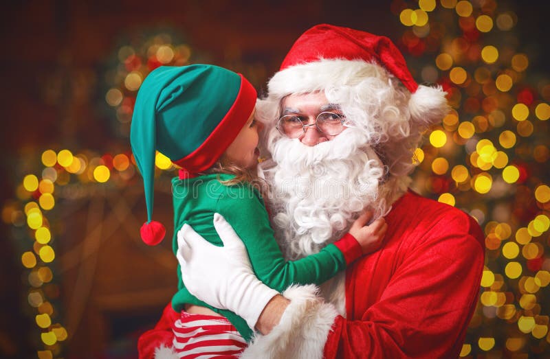Happy cheerful child elf helper and Santa Claus at Christmas royalty free stock photos Happy cheerful child elf helper and Santa Claus at Christmas royalty free stock photos