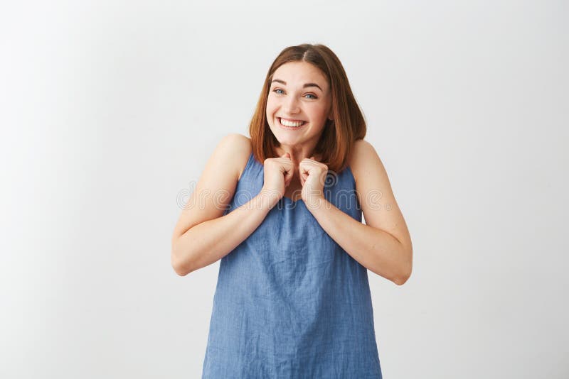 Happy cheerful young girl smiling rejoicing looking at camera over white background.