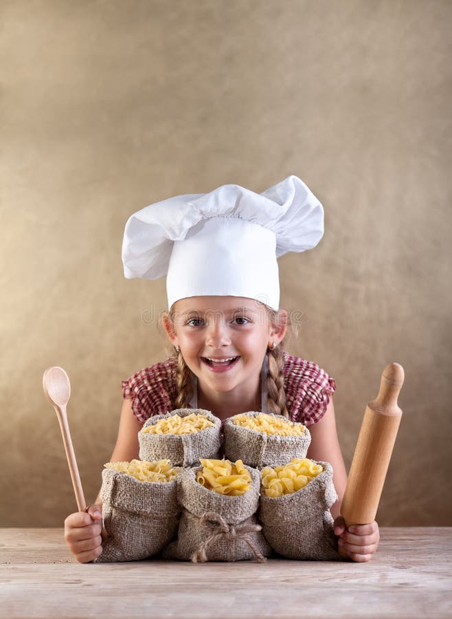 Happy chef child with pasta assortment