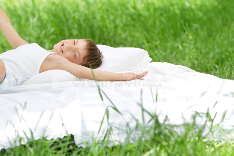 Happy child boy relaxing on nature