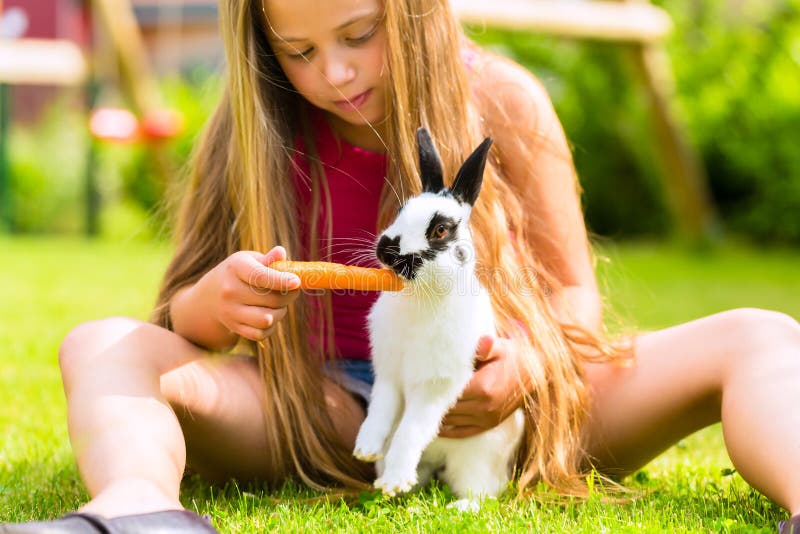 Happy child with bunny pet at home in garden royalty free stock photos Happy child with bunny pet at home in garden royalty free stock photos