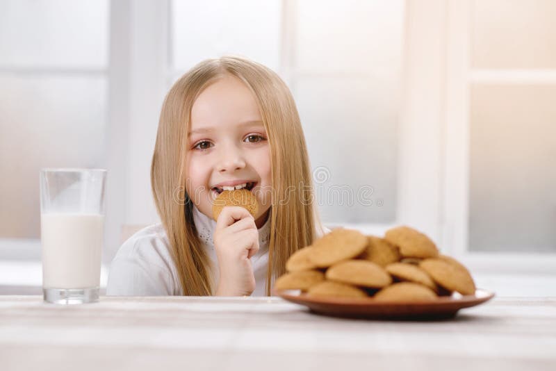 Happy child eats cookie. royalty free stock photography Happy child eats cookie. royalty free stock photography