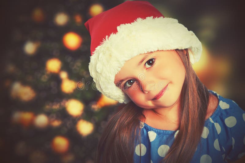 Happy child girl in a Christmas hat royalty free stock image
