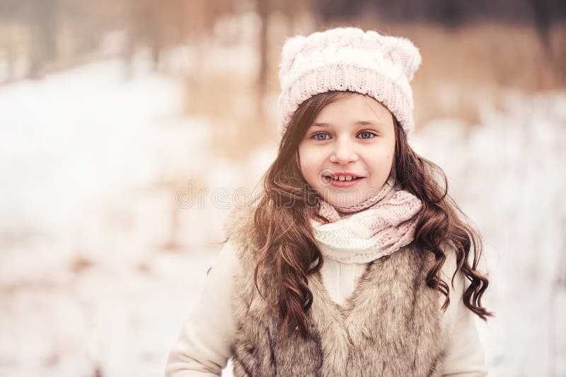 Happy child girl on cozy warm outdoor winter walk